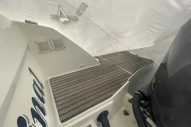 Slide: The Image of 2019 Jeanneau Leader 10.5 boat deck with Yamaha engine, featuring sleek wood finish. - 25