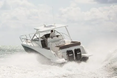 Slide: The Image of Manufacturer Provided Image: 2019 Jeanneau Leader 10.5 boat cruising on the ocean with twin 300 HP engines. - 4