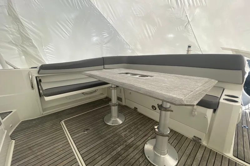 Slide: The Image of 2019 Jeanneau Leader 10.5 boat interior with sleek seating and modern table design. - 5