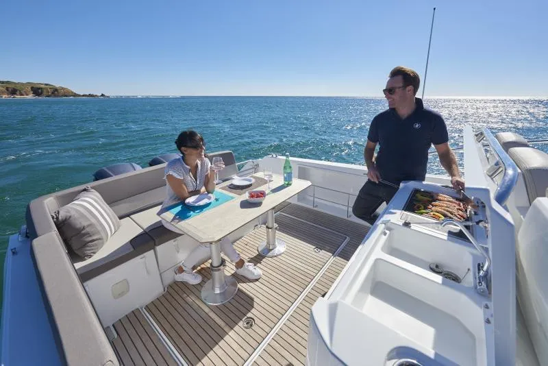 Slide: The Image of Manufacturer Provided Image: 2019 Jeanneau Leader 10.5 boat with people dining on deck. - 9
