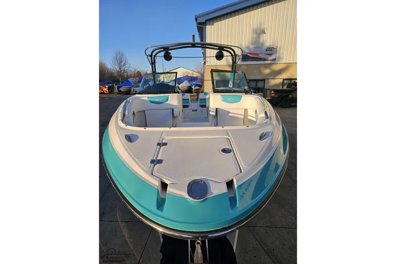 Slide: The Image of 2016 Chaparral Vortex 243 VRX boat with turquoise accents, docked outdoors. - 12