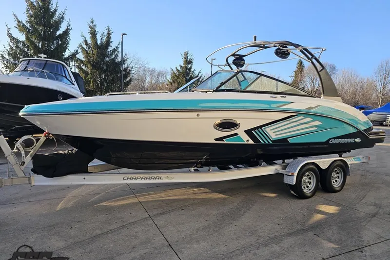 Slide: The Image of 2016 Chaparral Vortex 243 VRX boat on trailer, vibrant design, parked outdoors. - 15