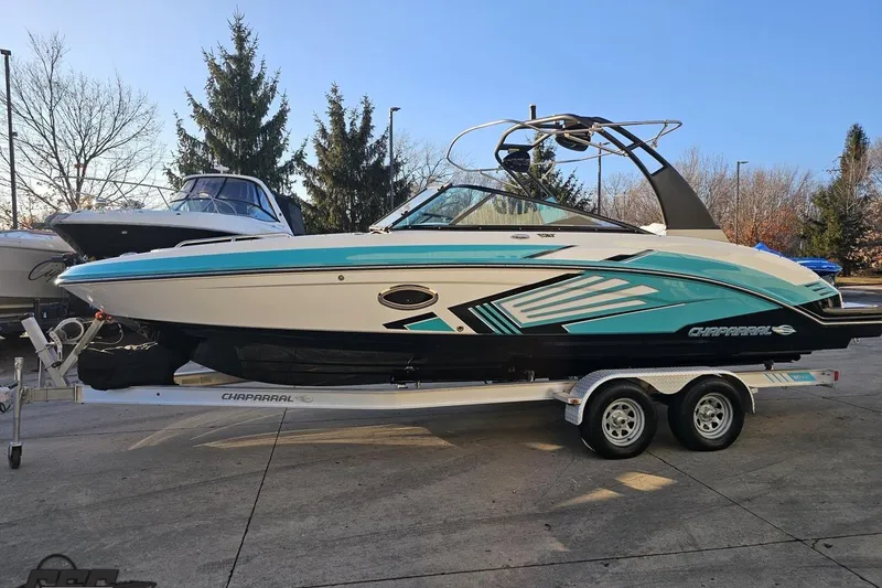 Slide: The Image of 2016 Chaparral Vortex 243 VRX boat on trailer, vibrant design, parked outdoors. - 16