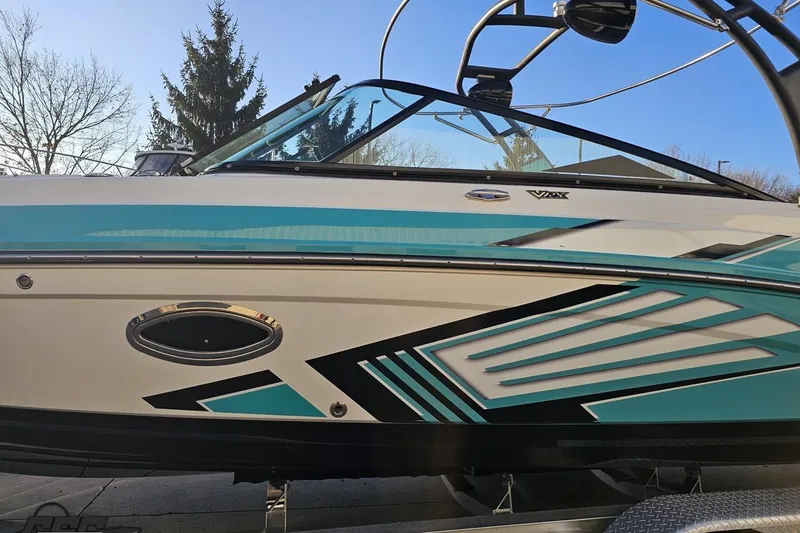 Slide: The Image of 2016 Chaparral Vortex 243 VRX boat with sleek turquoise and black design. - 18