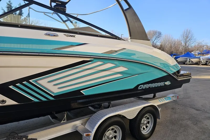 Slide: The Image of 2016 Chaparral Vortex 243 VRX boat on trailer, featuring sleek turquoise and black design. - 19