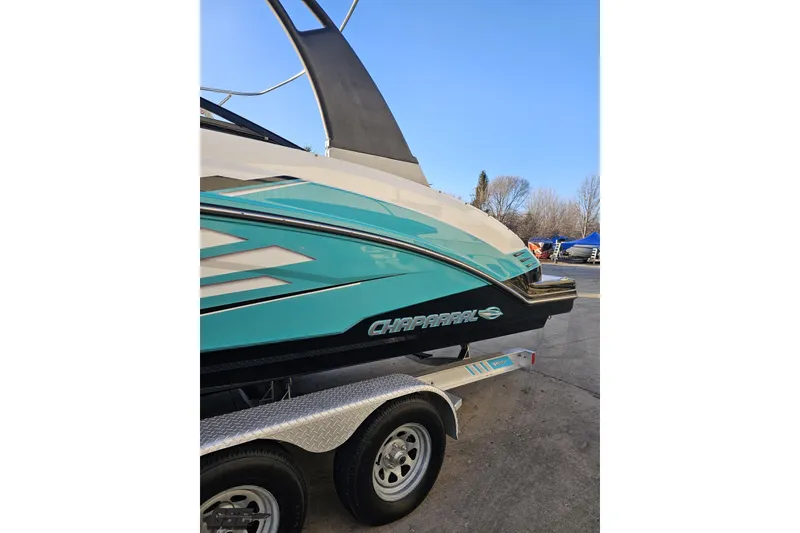 Slide: The Image of 2016 Chaparral Vortex 243 VRX boat on trailer, side view, blue and white design. - 22