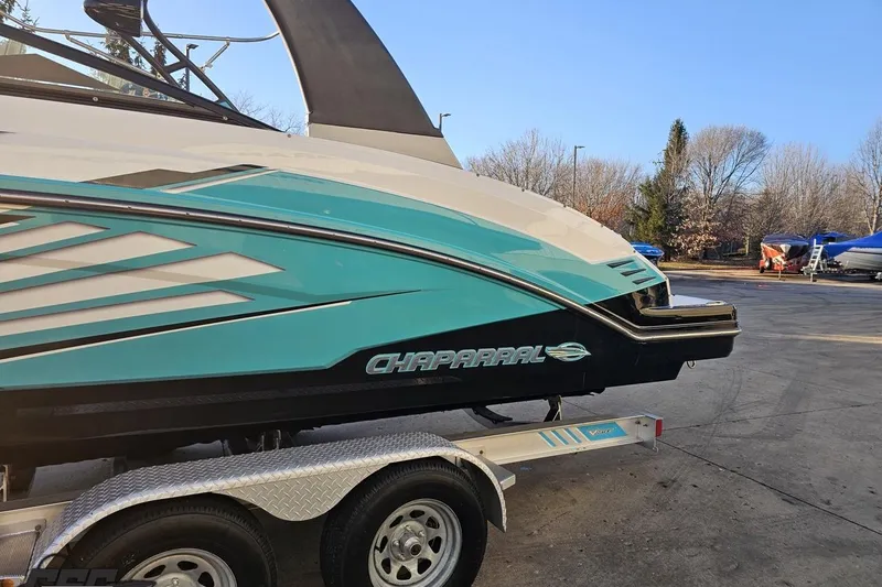 Slide: The Image of 2016 Chaparral Vortex 243 VRX boat on trailer, featuring sleek turquoise and black design. - 23