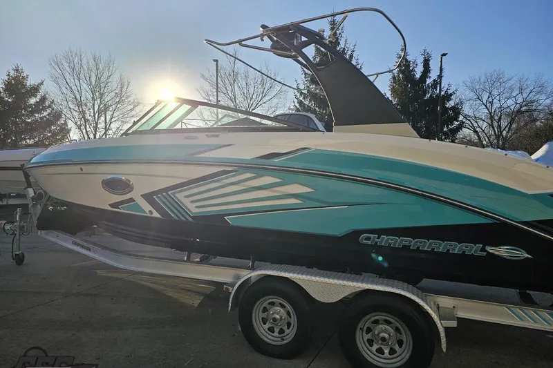 Slide: The Image of 2016 Chaparral Vortex 243 VRX boat on trailer, sunlit background. - 25