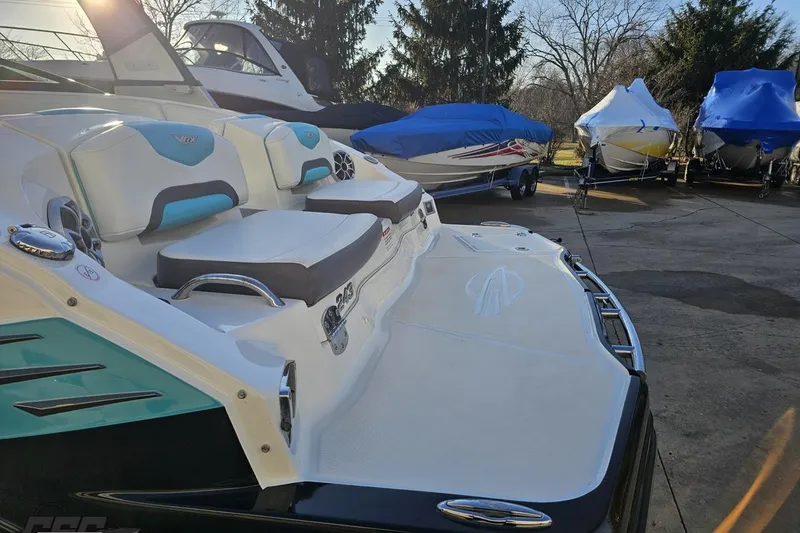 Slide: The Image of 2016 Chaparral Vortex 243 VRX boat with sleek seating and covered boats in the background. - 28
