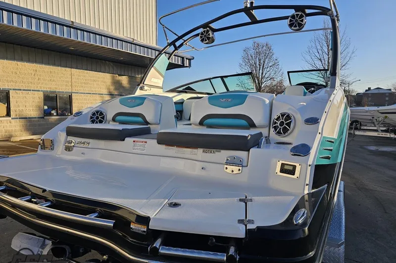 Slide: The Image of 2016 Chaparral Vortex 243 VRX boat with teal accents, docked outdoors. - 31