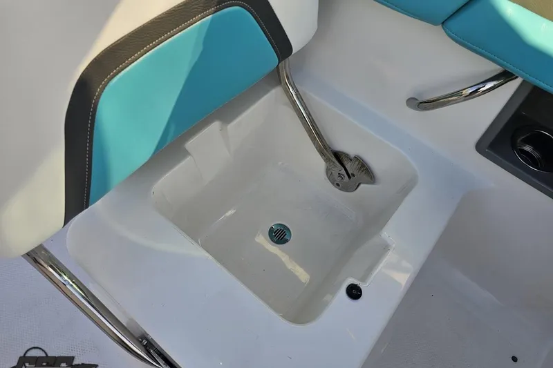 Slide: The Image of 2016 Chaparral Vortex 243 VRX boat interior with blue and white seating and storage compartment. - 52