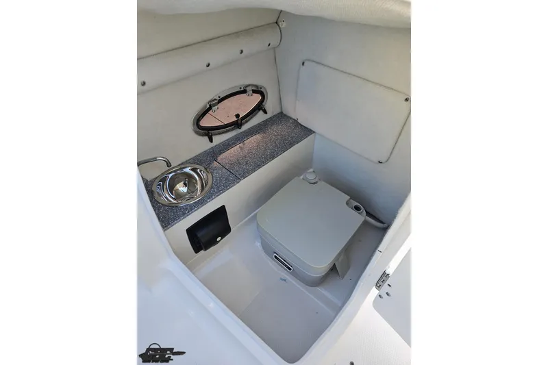 Slide: The Image of 2016 Chaparral Vortex 243 VRX boat interior with sink and portable toilet. - 54