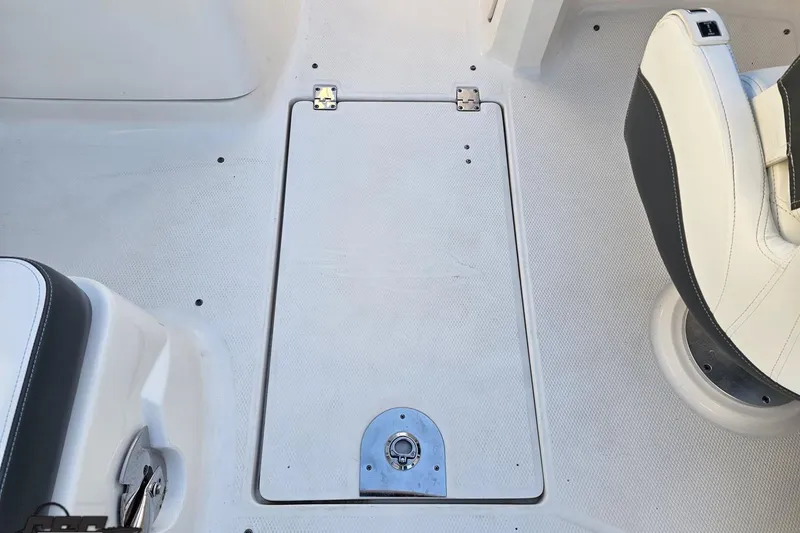 Slide: The Image of 2016 Chaparral Vortex 243 VRX boat interior with white seating and storage hatch. - 55