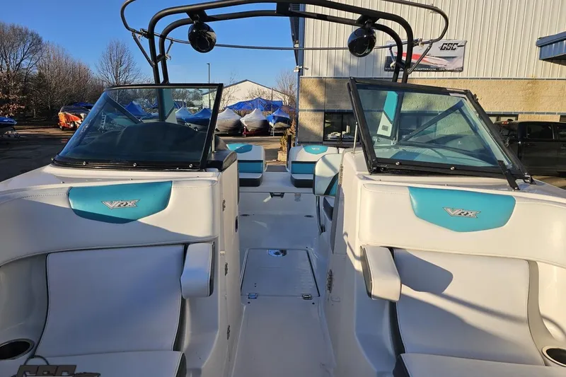 Slide: The Image of 2016 Chaparral Vortex 243 VRX boat interior with blue accents and dual windshields. - 79
