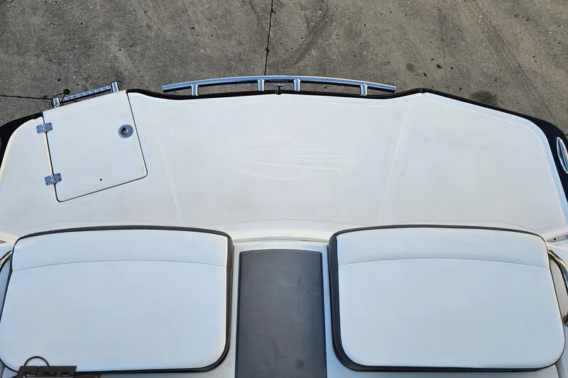 Slide: The Image of 2016 Chaparral Vortex 243 VRX boat deck with cushioned seating and storage hatch. - 86