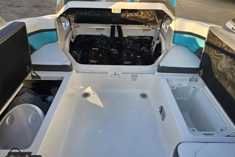 Slide: The Image of 2016 Chaparral Vortex 243 VRX boat interior with open storage compartments and engine bay. - 87