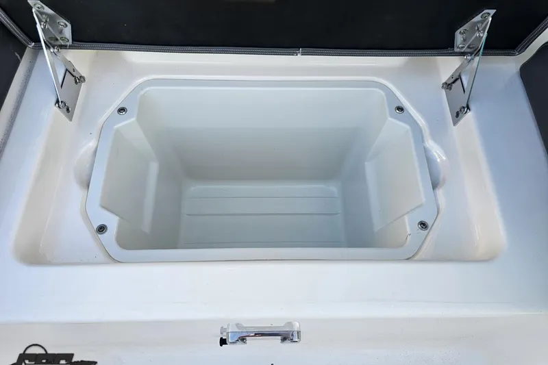 Slide: The Image of 2016 Chaparral Vortex 243 VRX storage compartment with open lid and metal hinges. - 88