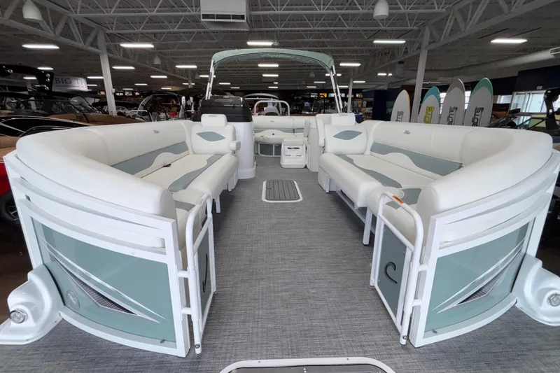 Slide: The Image of 2026 JC Neptoon 25TT Sport pontoon boat with spacious seating in showroom. - 11