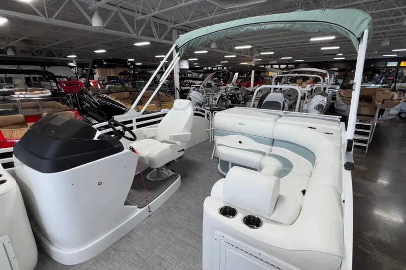 Slide: The Image of 2026 JC Neptoon 25TT Sport pontoon boat interior with white seating and helm. - 22