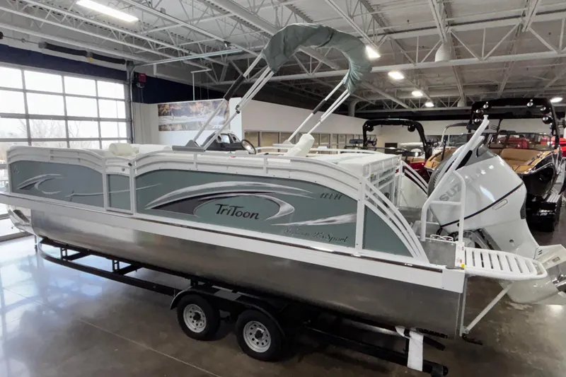 Slide: The Image of 2026 JC Neptoon 25TT Sport pontoon boat displayed indoors on a trailer. - 3