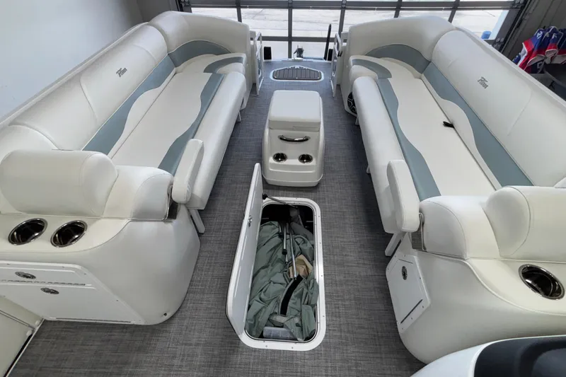 Slide: The Image of 2026 JC Neptoon 25TT Sport pontoon boat interior with white seating and storage compartment. - 41