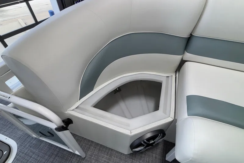 Slide: The Image of 2026 JC Neptoon 25TT Sport boat interior with storage compartment and speaker. - 48