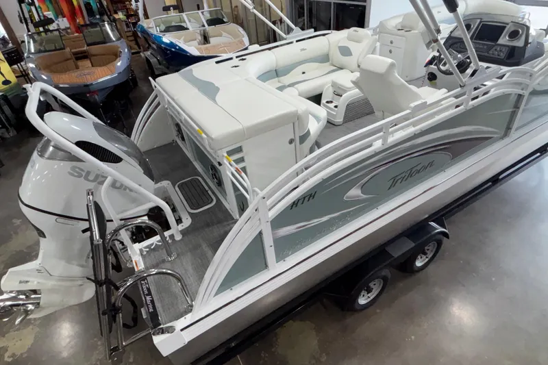 Slide: The Image of 2026 JC Neptoon 25TT Sport pontoon boat with Suzuki outboard motor in showroom. - 5