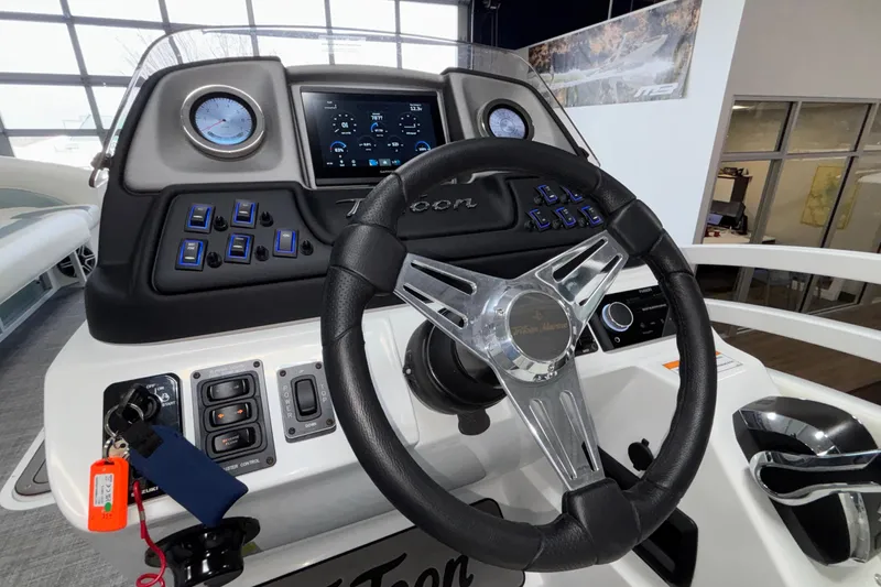 Slide: The Image of Steering console of 2026 JC Neptoon 25TT Sport boat with modern controls and display. - 24