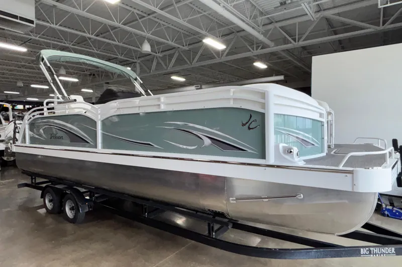 Slide: The Image of 2026 JC Neptoon 25TT Sport pontoon boat displayed indoors on a trailer. - 8