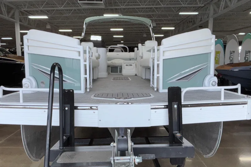 Slide: The Image of 2026 JC Neptoon 25TT Sport pontoon boat in showroom, rear view. - 9