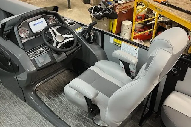 Slide: The Image of 2026 MONACO 235SFL boat cockpit with steering wheel and gray captain's chair. - 15