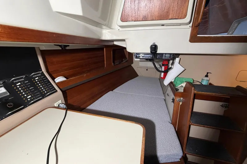 Slide: The Image of Interior of a 1984 C&C 35-3 sailboat with navigation equipment and cozy seating. - 12