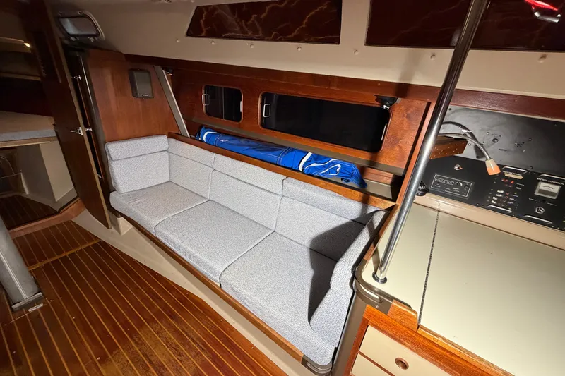 Slide: The Image of Interior of 1984 C&C 35-3 sailboat with wooden accents and gray seating. - 14