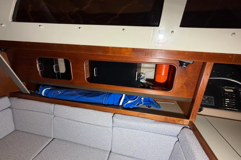 Slide: The Image of Interior of 1984 C&C 35-3 sailboat with wooden storage compartments and seating area. - 15