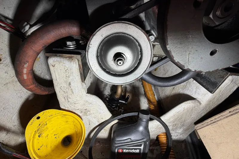 Slide: The Image of Engine compartment of a 1984 C&C 35-3 sailboat with maintenance tools and oil container. - 23