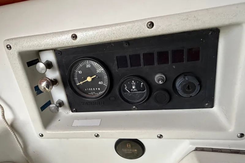 Slide: The Image of Control panel of a 1984 C&C 35-3 sailboat with RPM and fuel gauges. - 37