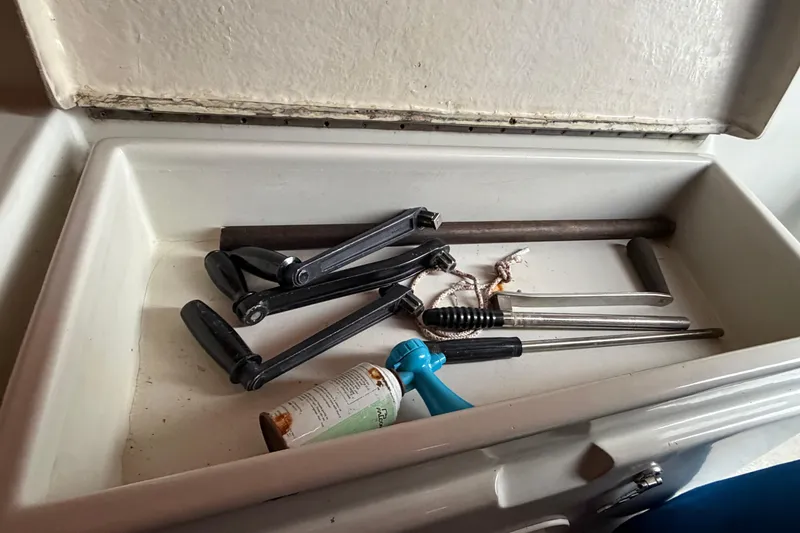 Slide: The Image of Tools and items inside a storage compartment on a 1984 C&C 35-3 sailboat. - 39