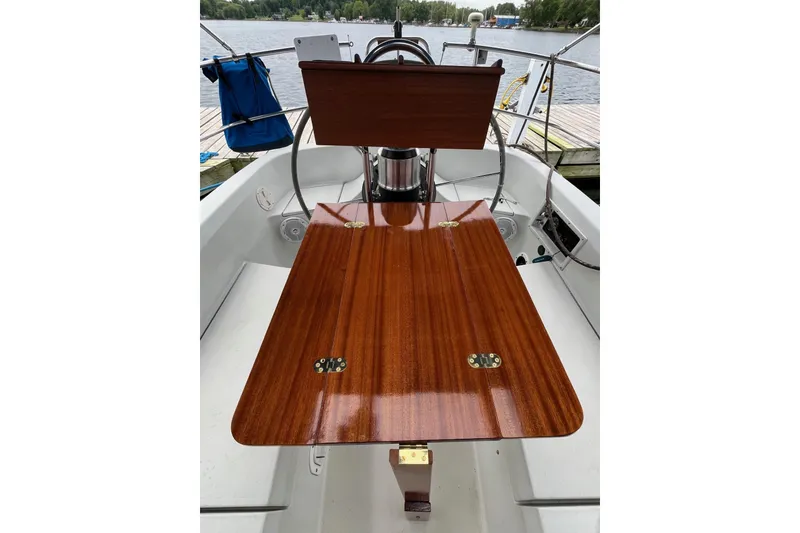 Slide: The Image of Cockpit of 1984 C&C 35-3 sailboat with polished wooden table and steering wheel. - 4