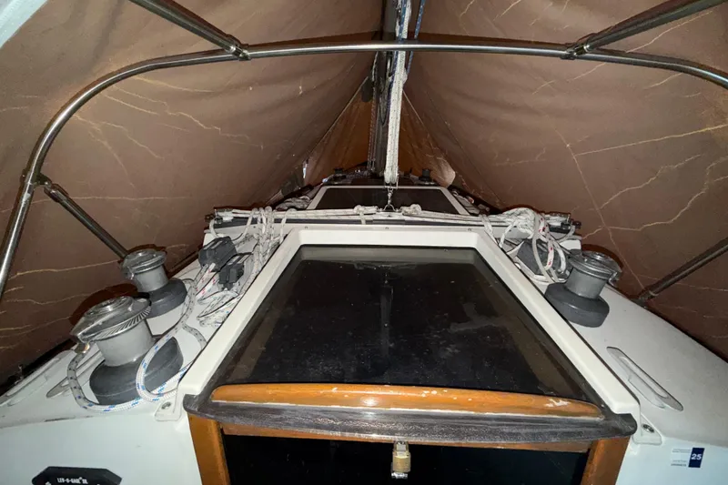 Slide: The Image of 1984 C&C 35-3 sailboat cockpit with winches and ropes under a protective cover. - 40
