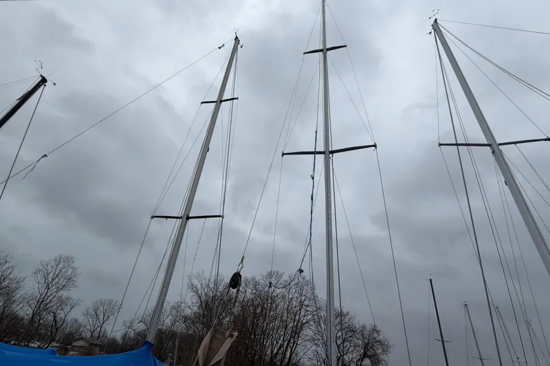 Slide: The Image of Tall masts of a 1984 C&C 35-3 sailboat against a cloudy sky. - 43