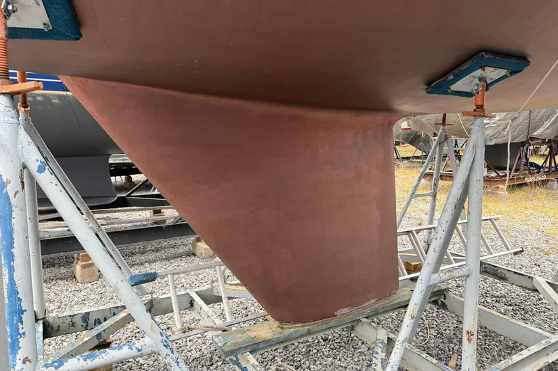 Slide: The Image of 1984 C&C 35-3 sailboat keel on stands, in a boatyard setting. - 45