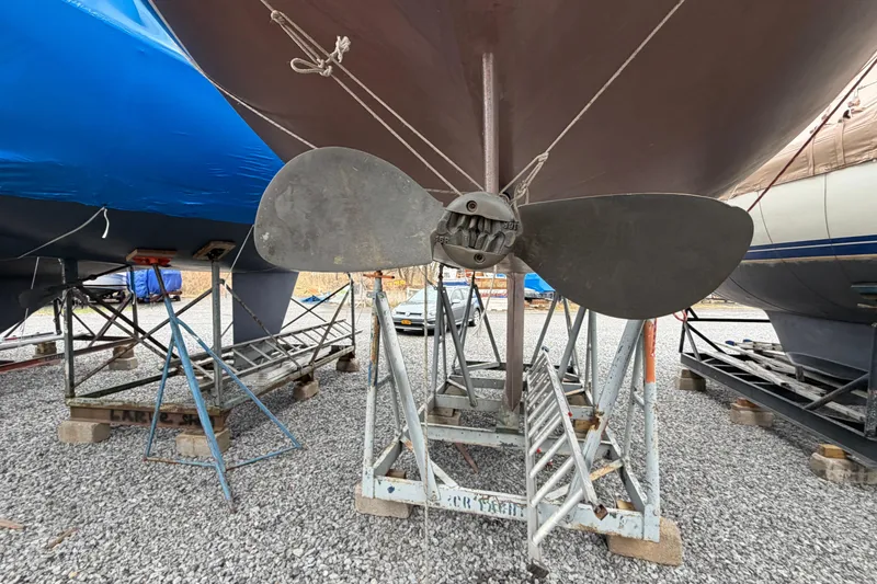 Slide: The Image of 1984 C&C 35-3 sailboat propeller on stands in a gravel boatyard. - 49