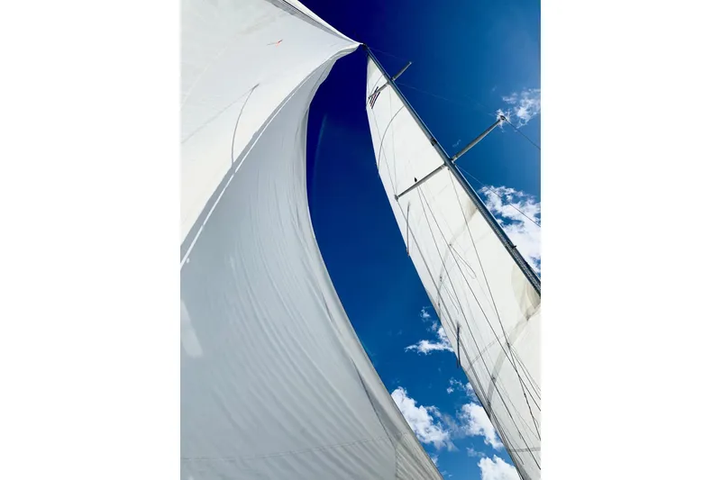 Slide: The Image of Sails of a 1984 C&C 35-3 yacht against a clear blue sky. - 5