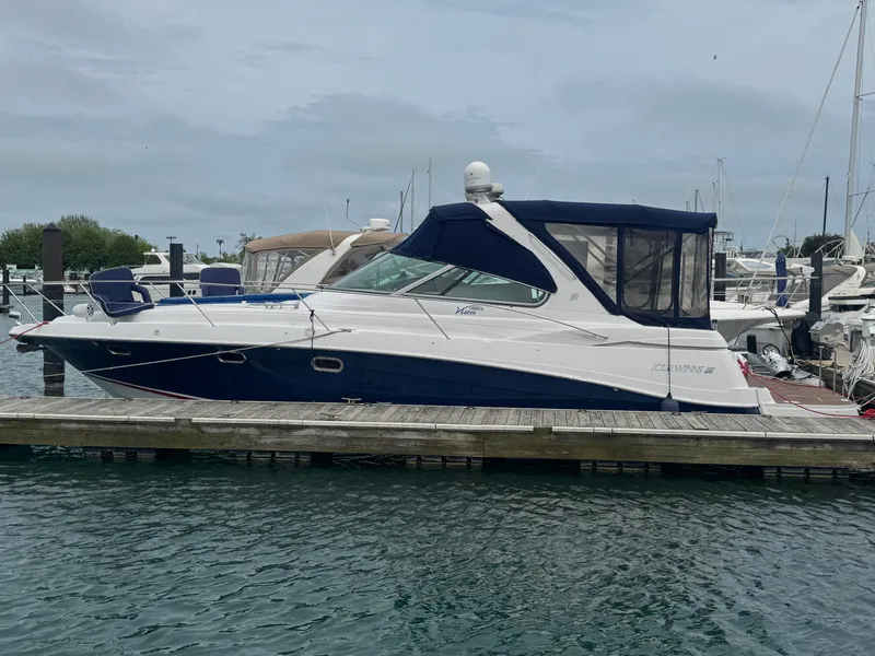 The Image of 2007 Four Winns 378 Vista yacht docked at marina, featuring sleek design and blue canopy. - 0