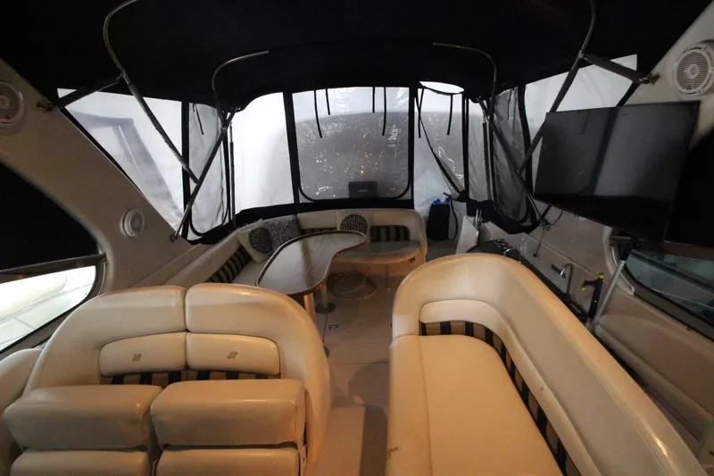 Slide: The Image of Interior of 2007 Four Winns 378 Vista yacht with beige seating and a covered deck area. - 12