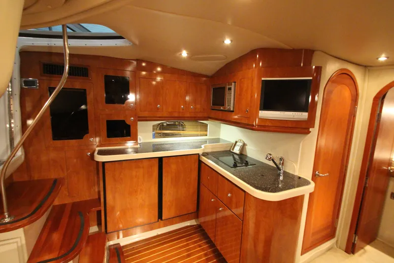 Slide: The Image of Luxurious 2007 Four Winns 378 Vista yacht interior with wood cabinetry and modern amenities. - 25