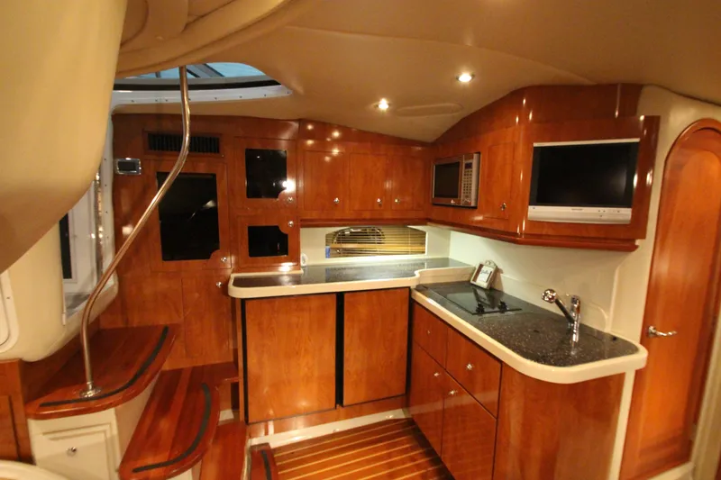 Slide: The Image of Luxurious 2007 Four Winns 378 Vista yacht interior with wood cabinetry and modern amenities. - 26