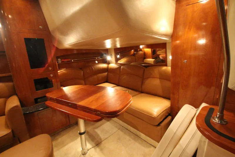 Slide: The Image of Luxurious interior of 2007 Four Winns 378 Vista yacht with leather seating and wooden table. - 31