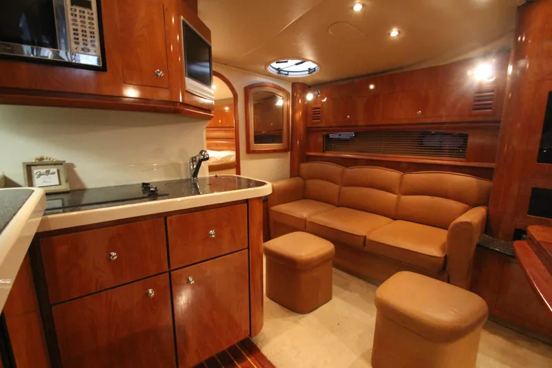 Slide: The Image of Luxurious interior of 2007 Four Winns 378 Vista yacht with leather seating and wood cabinetry. - 32