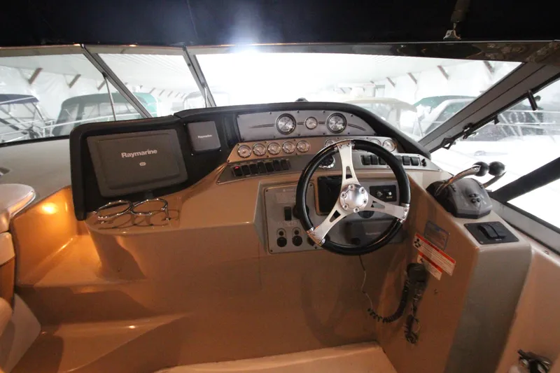 Slide: The Image of 2007 Four Winns 378 Vista boat helm with steering wheel and navigation controls. - 7